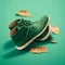 Pair of green sneakers on a green background with autumn leaves.