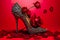 A pair of high heeled shoes with roses on them. Generative AI image.