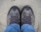 A pair of hiking boots on sandy ground