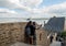 A pair of Hindus take a picture with a seagull in Mont Saint-Michel