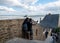 A pair of Hindus take a picture with a seagull in Mont Saint-Michel, the monastery and village on a tidal island