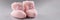 Pair of knitted pink baby booties with cute bow on it