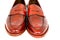 Pair of leather cherry calf penny loafer shoes together one by one closely