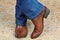 Pair of legs in cowboy boots and jeans on straw