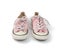 Pair of light pink worn textile sneakers with laces isolated on a white background