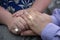 A pair of lovers hands wearing wedding rings and touching