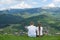 Pair of lovers sit on a hill and admire the view of the mountain