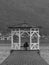 Pair of lovers under a gazebo on the pier of a lake