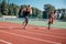 A pair of male athletes compete in running