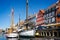 Pair of masted wooden sailing boat in the canal in the Nyhavn district of Copenhagen, Denmark