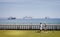 Pair of mature ladies playing bowls in front of collection of large cruise ships moored in Weymouth Bay  because of Coronavirus -