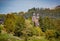 Pair of medieval steeples appear through the trees