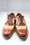 Pair of men`s vintage leather and net wing tip shoes, on white,