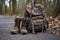 pair of muddy boots resting next to a backpack