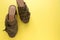 Pair of mules/clogs military green color on fresh yellow background