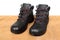 Pair of new black work boots made of genuine leather with a reinforced cape, the concept of special shoes for different