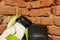 Pair of new boxer gloves against a brick wall. Two multicolored boxing gloves are in a corner of gym hall. Sports equipment