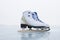 A pair of new leather skates in the snow on the ice of the sacred Lake Baikal in winter on a cloudy snowy day.