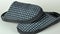A pair of new men's slippers with a beautiful pattern in gray tones. Warm and comfortable men's slippers on a