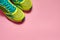 Pair of new sport shoes isolated on pink pastel background. New sneakers. Overhead shot of running foot wear.