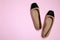 Pair of new stylish square toe ballet flats on pale pink background, flat lay. Space for text