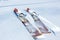 Pair of old fashioned wooden brown skis on white snow. Vintage winter background