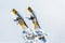 Pair of old fashioned wooden yellow skis on white snow