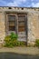 Pair of old wooden doors, rusted top section and chained closed.