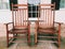 A pair of old wooden rocking chairs on the porch