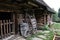 Pair of old wooden wheel barrows by the wooden cottage