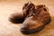 Pair of old worn shoes on wooden boad