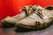 A pair of old yellow leather shoes. Dented men`s summer shoes. Close-up. Selective focus