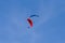 Pair of paragliders in flight. Two paragliders one red and one blue.