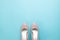Pair of pastel pink woman`s shoes on turquoise colour background,