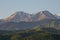 A pair of peaks of the mountains of the Trans-Ili Alatau meet the summer sunrise