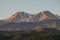 A pair of peaks of the mountains of the Trans-Ili Alatau meet the summer sunrise
