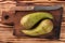 Pair of pears on old rural wooden cutting board with knife, top view