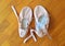 A pair of pink ballet shoes on parquet flooring