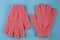 A pair of pink massage gloves for shower on blue background