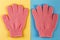 A pair of pink massage gloves for shower on blue and yellow background