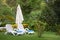 Pair of plastic sun loungers on green grass in a secluded place