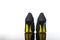 pair of pointed woman shoes with black soles yellow high heels