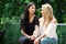 A pair of proud lesbian in outdoors looking at each other, in a garden background