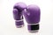 Pair of purple boxing gloves isolated on a white background