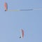 Pair of reckless pilots performs aerial acrobatics on board paramotors with the use of a banner