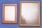 A pair of rectangular shaped photo frames with edges of different material.