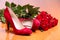Pair of red female shoes and bunch of red roses