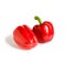 Pair of red paprika peppers on white isolated background