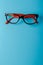 pair of red plastic-rimmed eyeglasses