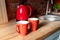 Pair Red polka dot retro vintage coffe tea mugs on wooden kithen counter at rustic room interior on breakfast time. Two